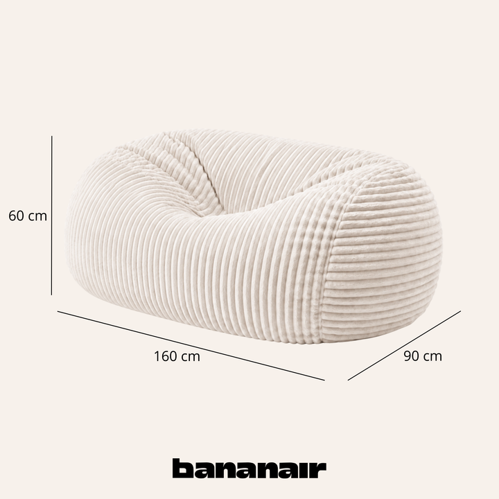 Pouf long géant déhoussable en fourrure côtelée blanc cassé, dimensions indiquées 160x90x60 cm